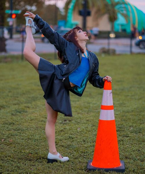 Person stretching outdoors during a sunrise, looking energetic and refreshed.